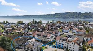 an aerial view of a city with a lake at Bodenseehotel Krone & Gästehaus in Bodman-Ludwigshafen