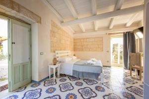 a bedroom with a bed in a room with a window at Tenuta Monsalvato in Otranto