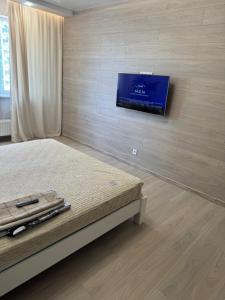 a bedroom with a bed and a tv on a wall at Дім Гаваї in Chechelivka +7 photos