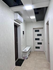 a bathroom with a white toilet and a door at Дім Гаваї in Chechelivka