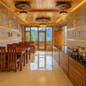a large kitchen with a dining room with tables and chairs at The Manali Suites & Villas, Manali - Luxury Stay Away From City Hustle in Manāli