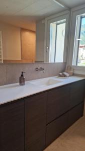 a kitchen with a sink and a mirror at Lake Como Terrace Suite in Mandello del Lario