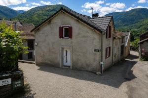 a small house with red shutters on a mountain at Maison 8 personnes avec terrasse in Verdun
