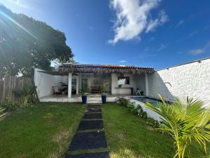 a backyard with a pool and a house at Casa Rio - Santo Amaro in Santo Amaro