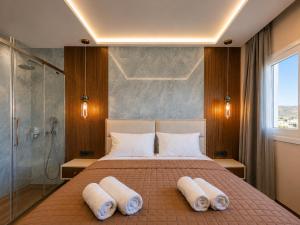a bedroom with a bed with pillows and a shower at Vista Maris Suites in Amoopi +89 photos