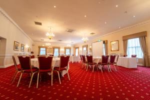 a room with a long table and chairs in it at Farington Lodge Hotel in Preston