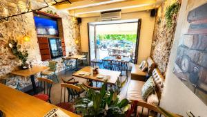 a restaurant with tables and chairs in a room at Atlantis Hotel in Agios Nikolaos