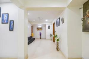 a hallway of a hospital with paintings on the walls at FabHotel The Lalit Vibes - Nr DLF Phase 2 & MG Road Metro in Gurgaon