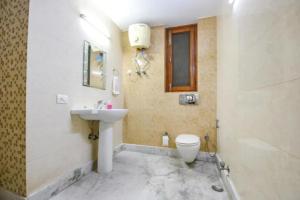 a bathroom with a sink and a toilet at FabHotel The Lalit Vibes - Nr DLF Phase 2 & MG Road Metro in Gurgaon +30 photos