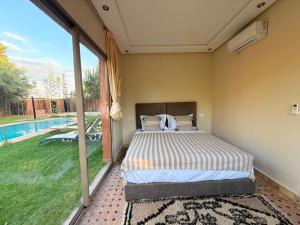 a bedroom with a bed and a swimming pool at Villa avec Piscine Chauffée Privée pour Familles in Marrakesh +46 photos