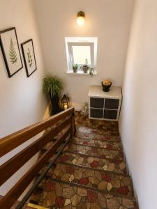 a staircase with a stone floor and a mirror at Apartma Tanja bike-friendly in Limbuš +32 photos