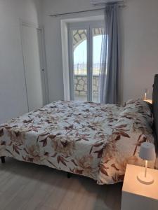 a bedroom with a bed and a window at Casa Enza in Forio d'Ischia +9 photos