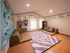 a living room with a couch and a large rug at みどりの風 -那須高原中心地-森を感じる貸切一軒家-観光や買い物に便利-無料bbq-最大7名-子供歓迎 in Nasu