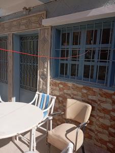 a pair of chairs and a table in front of a building at Saïda Friends in Zemmour Touirza