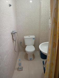 a bathroom with a toilet and a sink at Saïda Friends in Zemmour Touirza