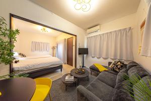 a living room with a couch and a bed at Otter Stay - Masaki in Nagoya +45 photos
