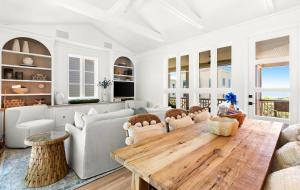 a living room with a wooden table and chairs at Luv U Honey in Santa Rosa Beach