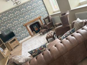 a living room with a couch and a fireplace at The Old Bank in Warrenpoint