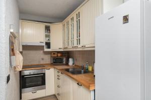 a kitchen with white cabinets and a sink at House Toma in Oklaj