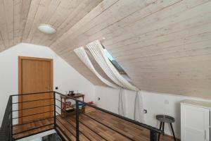 a staircase in a house with a wooden ceiling at House Toma in Oklaj