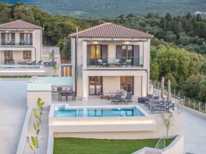 a villa with a swimming pool and a house at Agemaya Villas in Sami