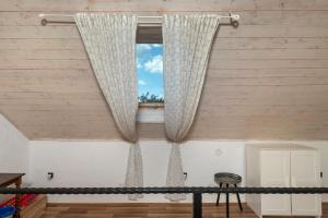 a window in a room with curtains and a stool at House Toma in Oklaj +45 photos