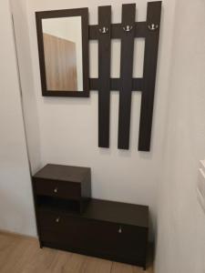 a black dresser with a mirror on a wall at Ubytovna Chropyně in Kroměříž