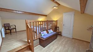 a room with a crib with a bed in it at Sous les serves in Saint-Léonard-de-Noblat