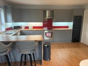 a kitchen with a wooden table and a counter top at Doherty,s Chalet in Doon +2 photos