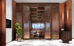 a lobby with a glass door with a dining room at Ibis Bangkok Siam Ratchathewi in Bangkok