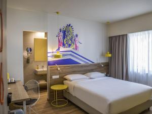 a hotel room with a bed and a desk and a sink at ibis Styles Athens Routes in Athens +136 photos