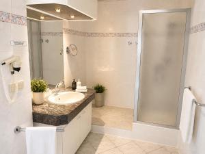 a bathroom with a sink and a shower at Hotel zum Felsenkeller Oybin in Oybin +18 photos