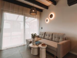 a living room with a couch and a table at Palmera in Władysławowo