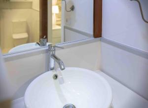 a bathroom with a white sink and a mirror at Numancia 1-1A in Las Palmas de Gran Canaria +49 photos