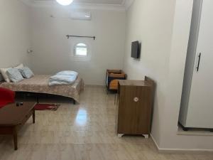 a room with a bed and a table in it at Motel EL Golla 