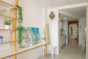 a room with white walls and a table and shelves at Numancia 1-1A in Las Palmas de Gran Canaria
