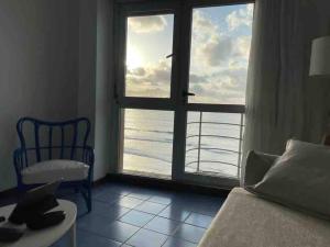 a room with a window with a view of the ocean at Numancia 1 - 2A in Las Palmas de Gran Canaria