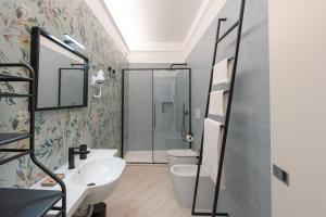 a bathroom with a sink and a toilet and a shower at Parmenide Family Apartment in Ascea +25 photos