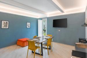 a dining room with a table and chairs at Parmenide Family Apartment in Ascea
