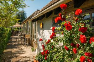 a house with red roses on the side of it at Crown & Punchbowl in Cambridge