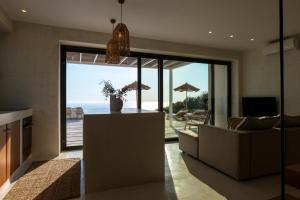 a living room with a view of the ocean at NeRó Villas Lefkada in Tsoukalades
