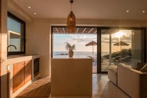 a kitchen with a view of the ocean at NeRó Villas Lefkada in Tsoukalades