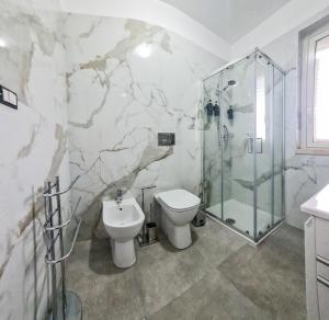 a bathroom with a toilet and a shower at Dream Houses in Marina di Palma +45 photos