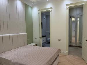 a bedroom with a bed and a bathroom at Casa de prime in Baku