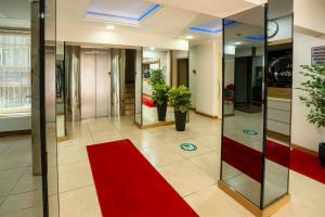 a lobby with a red carpet and glass doors at La Garden Hotel Old City in Istanbul