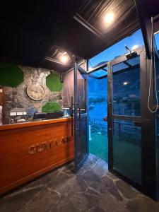 a kitchen with a glass door with a view at Gumaan Resort in Skardu