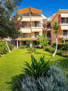 a large apartment building with a green yard at Akrogiali Studios - Nidri, Lefkada in Nydri +38 photos