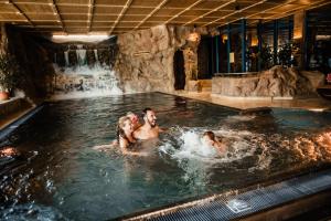 a group of people in a swimming pool at Spa Camping Schwarzwälder Hof in Seelbach