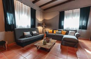 a living room with two couches and a coffee table at Bodega Andrés Iniesta con visita y cata in Fuentealbilla