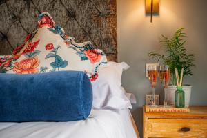 a bedroom with a bed with a pillow and a nightstand at Crown & Punchbowl in Cambridge